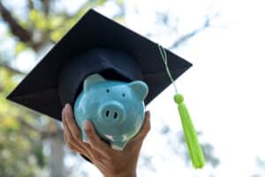Education loan for study abroad - piggy bank with graduation cap savings concept